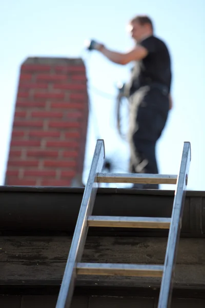 Technician working on a chimney on a Hanover home